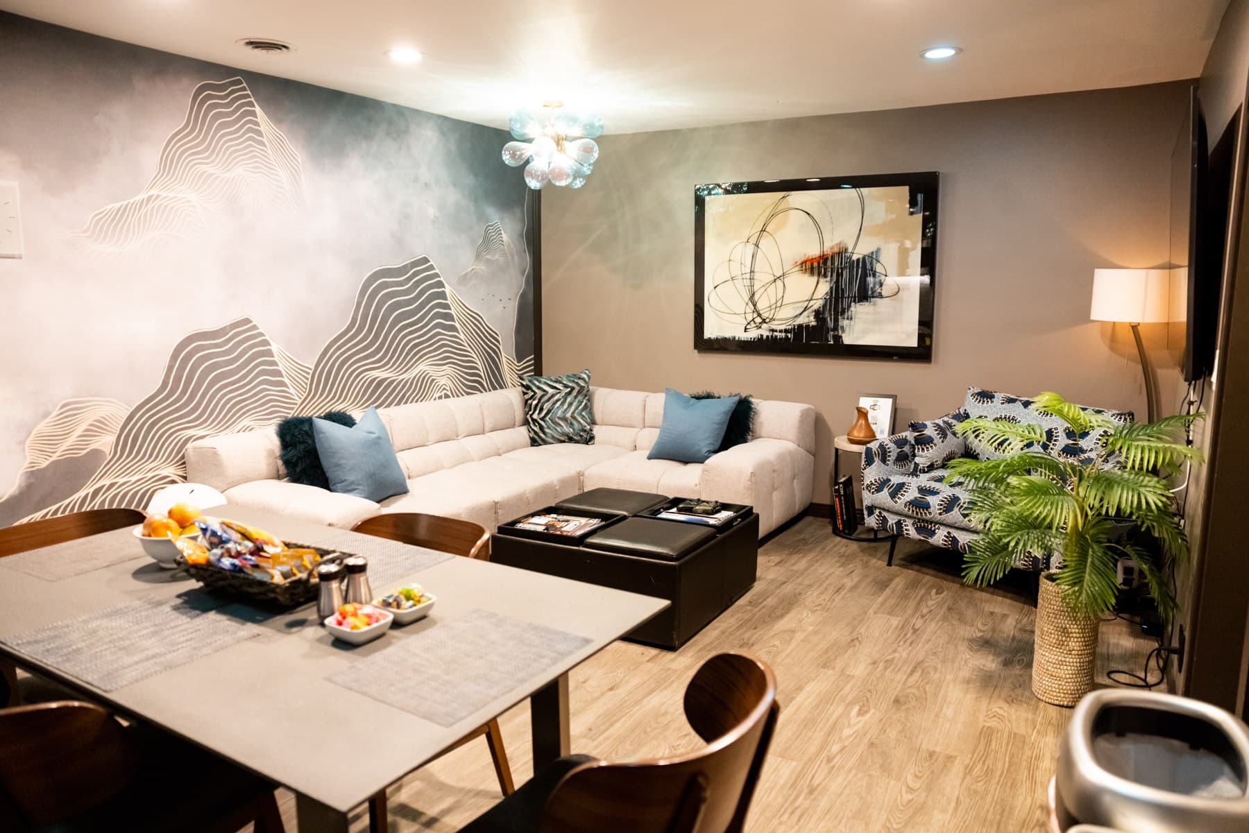 The artist lounge at Clear Lake — sectional couch, mountain mural, and warm lighting.